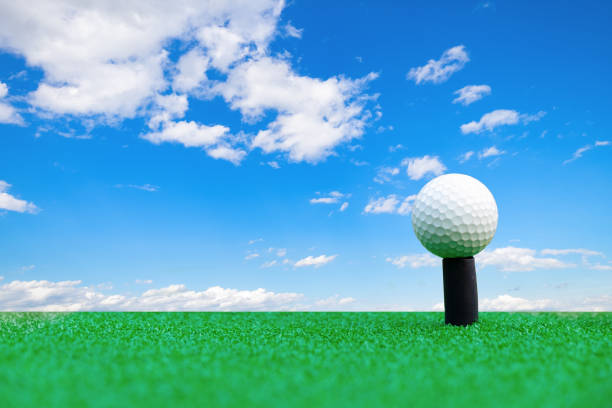 istock Golf ball on the green grass with blue sky background and copy space. 947338656