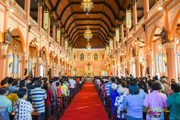 Chantaburi, Thailand - January 1, 2016: Group of pastors doing religion ceremony while Chistian people standing to attend religion ceremony in occasion of new year festival in beautiful church in Chantaburi, Thailand
