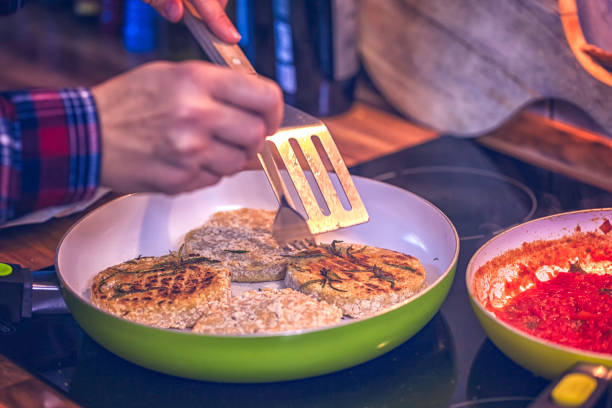 istock Preparing Vegetarian Tofu Burger with Tomato, Cucumber, Cheese and Salad 947340660