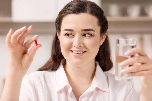 istock Joyful positive woman getting pills 947343170