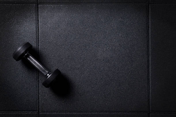 istock Gym background with dumbbell on dark floor 947343978