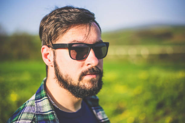 A man in a shirt and sunglasses