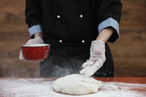 istock the cook makes flour for baking on the table 947345178