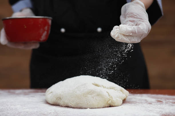 istock the cook makes flour for baking on the table 947345220