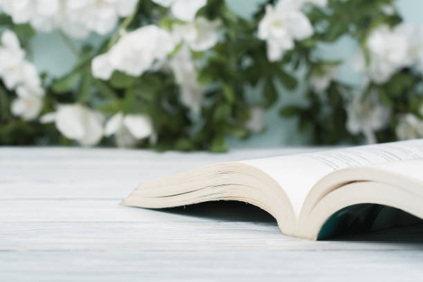 istock Open hardback book on wooden table. natural background. Back to school. Copy space for text 947345544