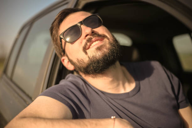 istock A handsome guy with sunglasses looking at the sky 947345554