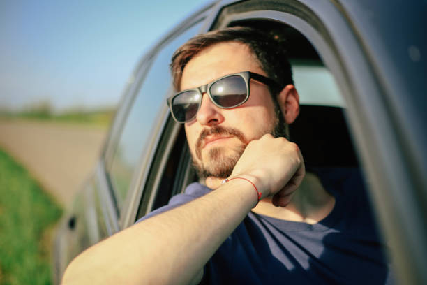 istock Hipster with glasses in the car 947345668