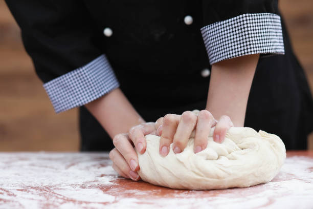 the cook makes flour out of flour for baking on the table