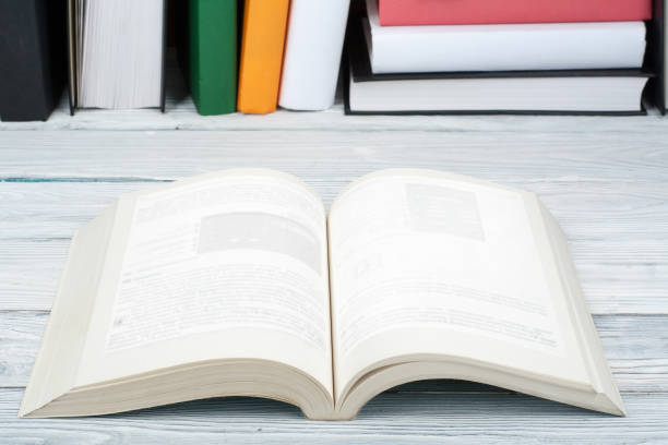 istock Open book, hardback colorful books on wooden table. Back to school. Copy space for text. Education business concept 947347972