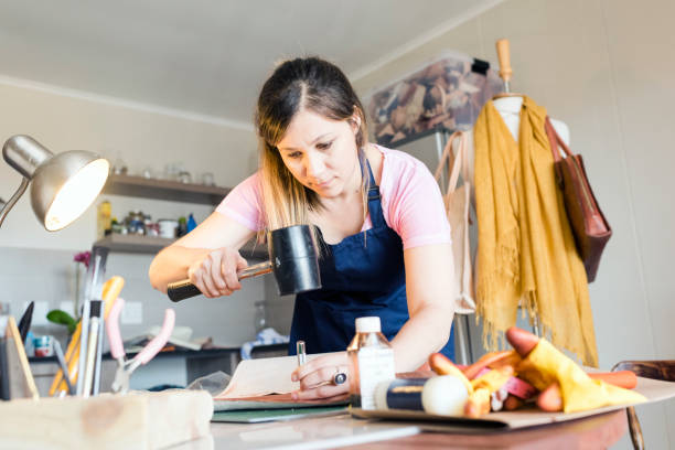 istock Young woman working with leather 947348590