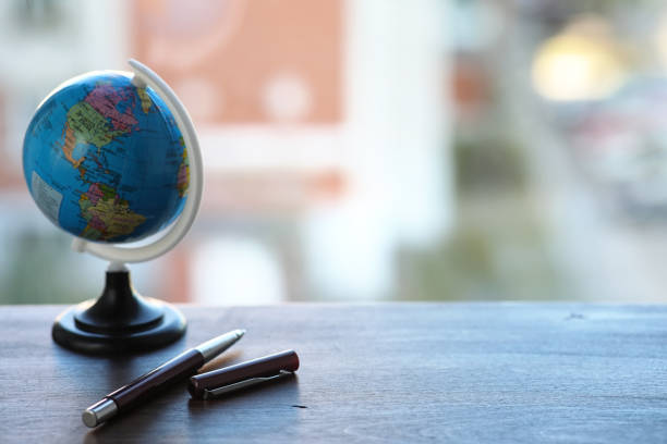 istock A pen on the desk and a small globe 947348794