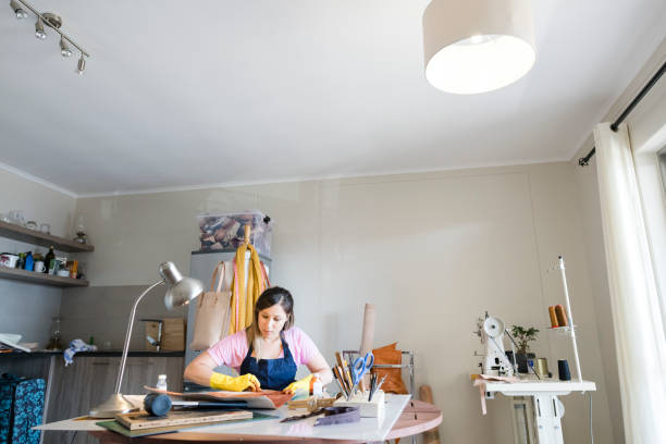 istock Young woman artisan working with leather 947353786