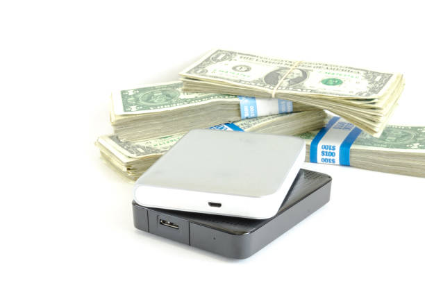 istock Portable drive USB on dollars pile for data is money concept 947358508