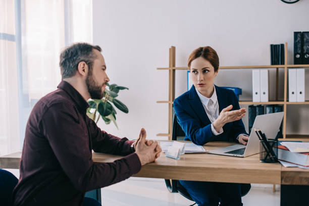 istock businesswoman and client discussing contract at workplace in office 947358784