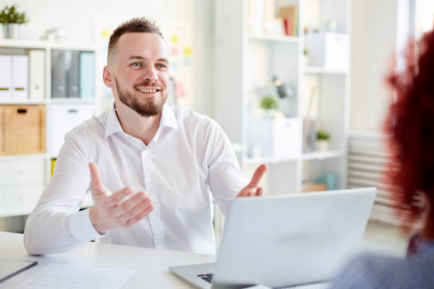istock White collar worker talking to colleague 947358866