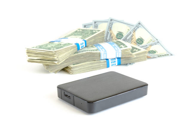 istock Portable drive USB on dollars pile for data is money concept 947359040