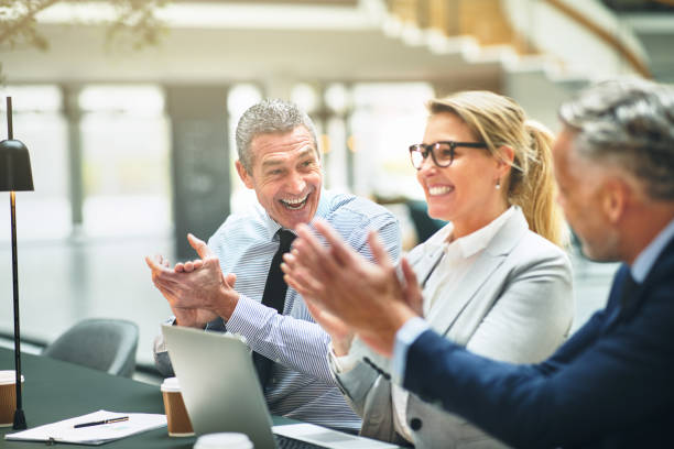 istock Mature office colleagues smiling and clapping together after a presentation 947363980