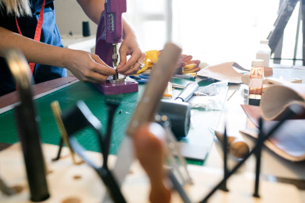 istock Woman artisan working with leather 947364324