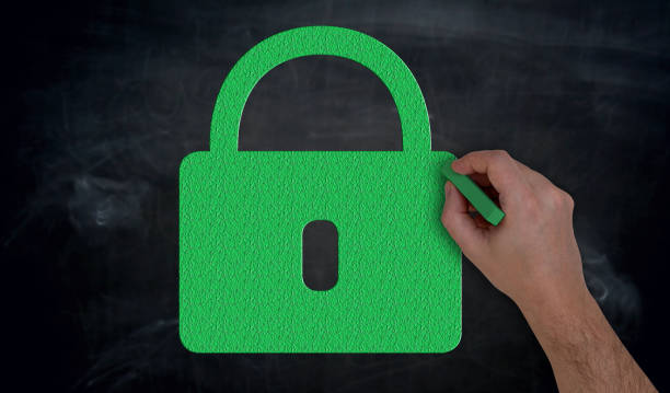 istock Hand paints with chalk green U-lock on blackboard concept 947367740