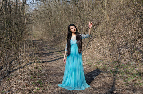 istock girl in a forest in a beautiful dress 947368564