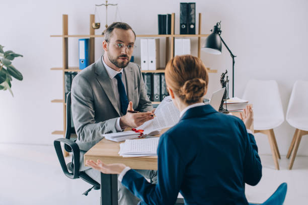 istock partial view of lawyers discussing contract at workplace in office 947368630