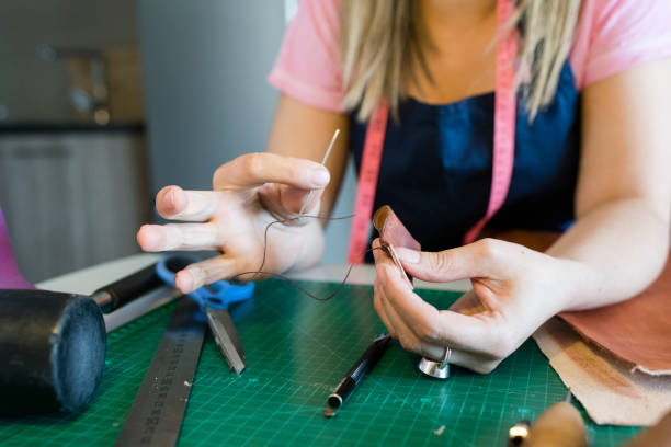 istock Close up of young woman working with leather 947371786