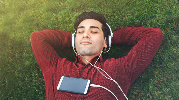 istock Young man relaxing in the park 947371870