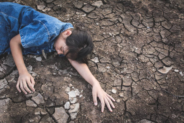 istock High Angle View Of Girl Lying On Arid Field 947372832