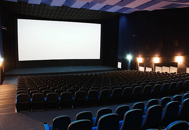 People sitting in an art deco cinema, Lyme Regis, UK