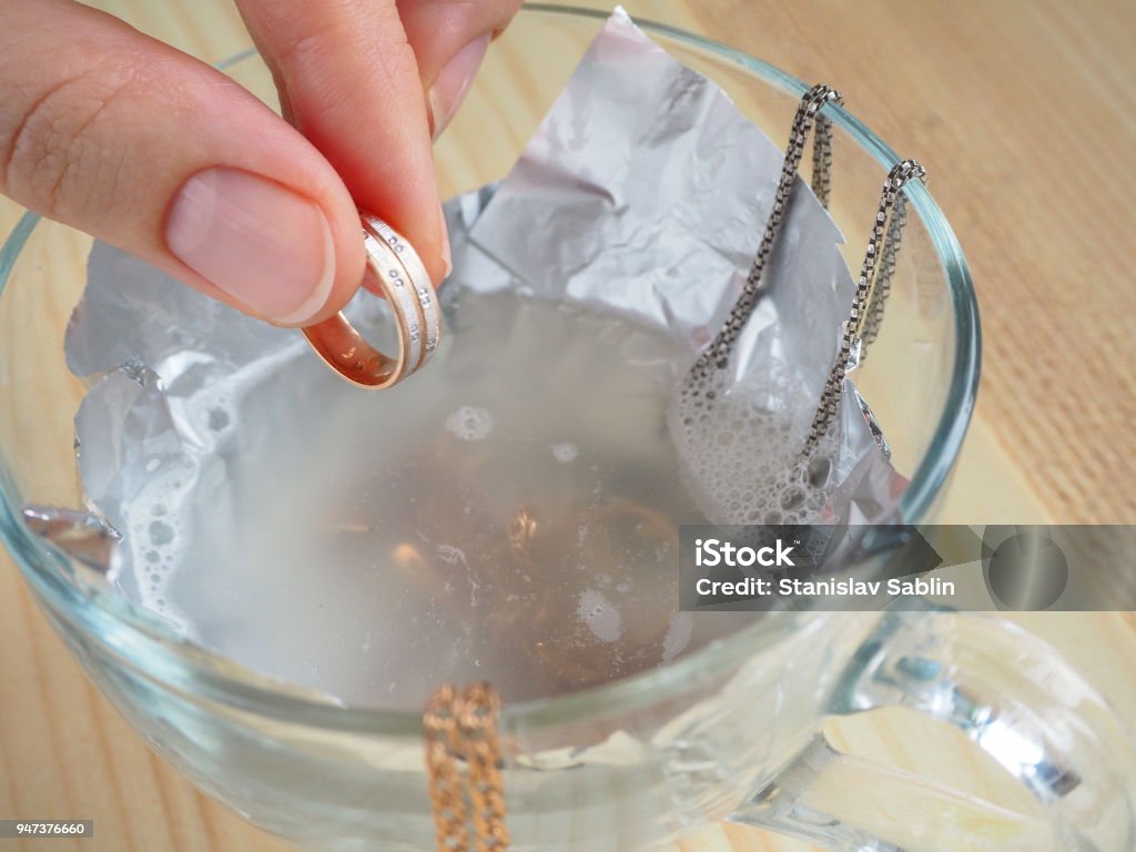 Cleaning gold and silver jewelry. Cleaning women jewelry concept. Jewelry Stock Photo