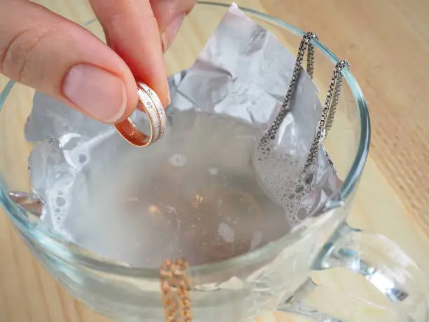 Photo of Cleaning gold and silver jewelry. Cleaning women jewelry concept.