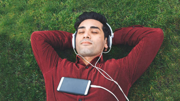 istock Young man relaxing in the park 947378156