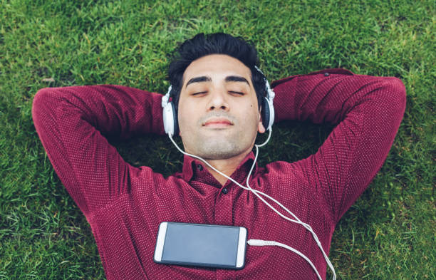 istock Young man relaxing in the park 947378402