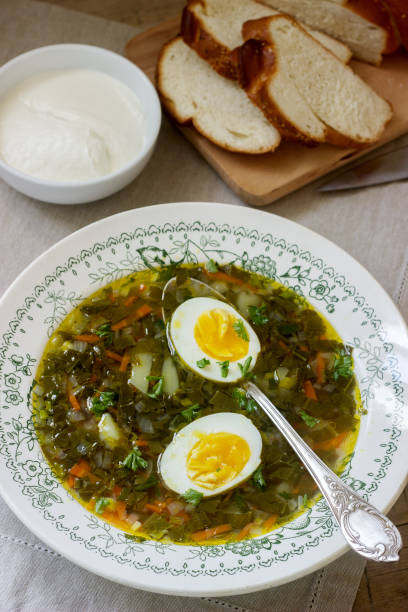 istock Vegetarian sorrel soup with egg, served with sour cream and bread. Rustic style. 947382002