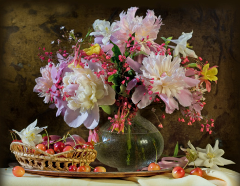 peony flowers and daisies in a glass vase and 