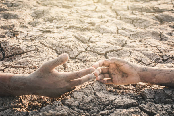 istock Cropped Image Of People With Muddy Hands On Ground 947387568