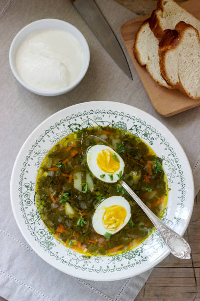 istock Vegetarian sorrel soup with egg, served with sour cream and bread. Rustic style. 947388056