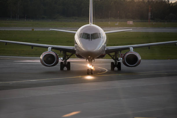 istock Airplane in airport at sun set 947389382
