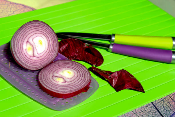 Red onion on cutting Board with knives