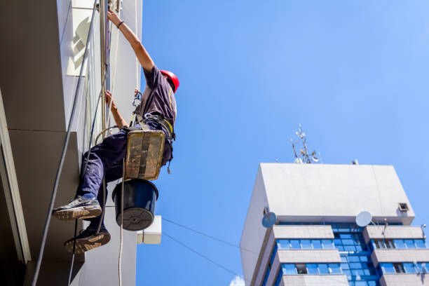 istock Industrial climber is washing, cleaning facade of a modern office 947392016