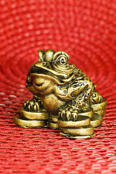 istock Figurine - Gold Chinese Money Frog on Red Textured Background 94739334