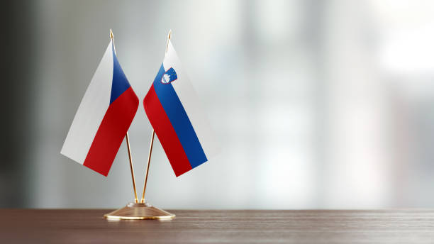 istock Czech And Slovenian Flag Pair On A Desk Over Defocused Background 947393766