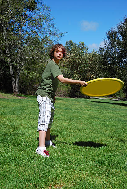 istock Teen Boy Throwing Frisbee 94739617