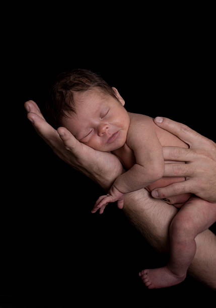 istock Newborn Baby Held in Father's Arm and Hands 94740213