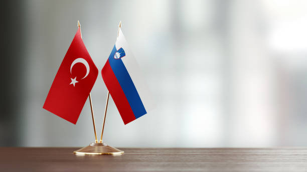 istock Turkish And Slovenian Flag Pair On A Desk Over Defocused Background 947407314