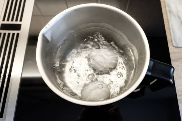 istock Boiling eggs in a stainless steel pot on a stove 947409226