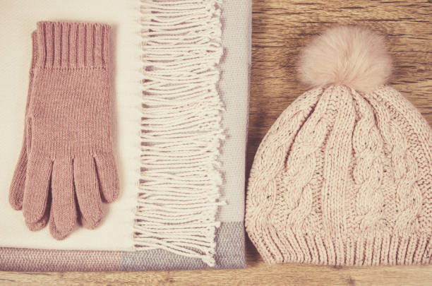 istock Warm winter knitted clothes on a wooden background. 947409550