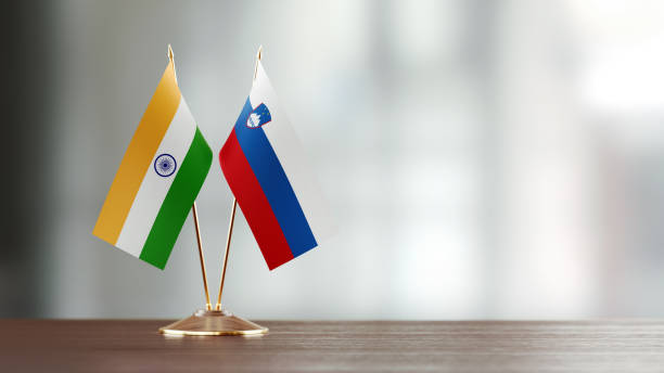 istock Indian And Slovenian Flag Pair On A Desk Over Defocused Background 947412694