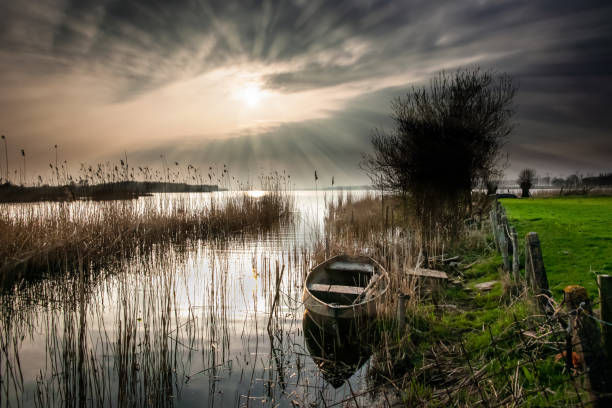 istock Beautiful sky just before sunrise over a calm river or lake at springtime 947413604