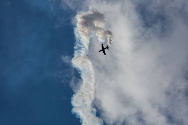 istock Jet airplane on airshow with smoke and trails 947414202